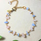 Laganna handmade Petal and Sea gold wire wrapped bracelet with rose quartz and aquamarine for love and calm on soft background with leaves