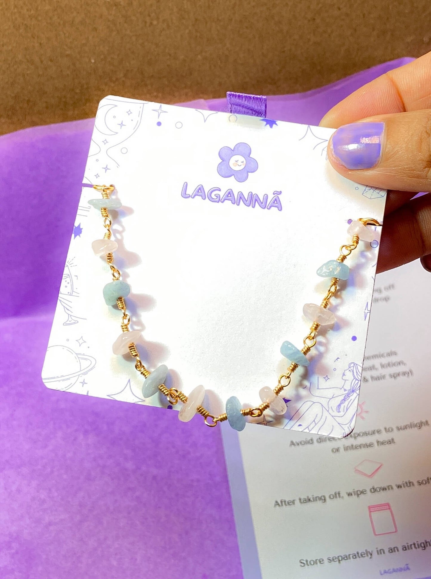 Laganna handmade Petal and Sea gold wire wrapped bracelet with rose quartz and aquamarine for love and calm on Laganna jewelry card