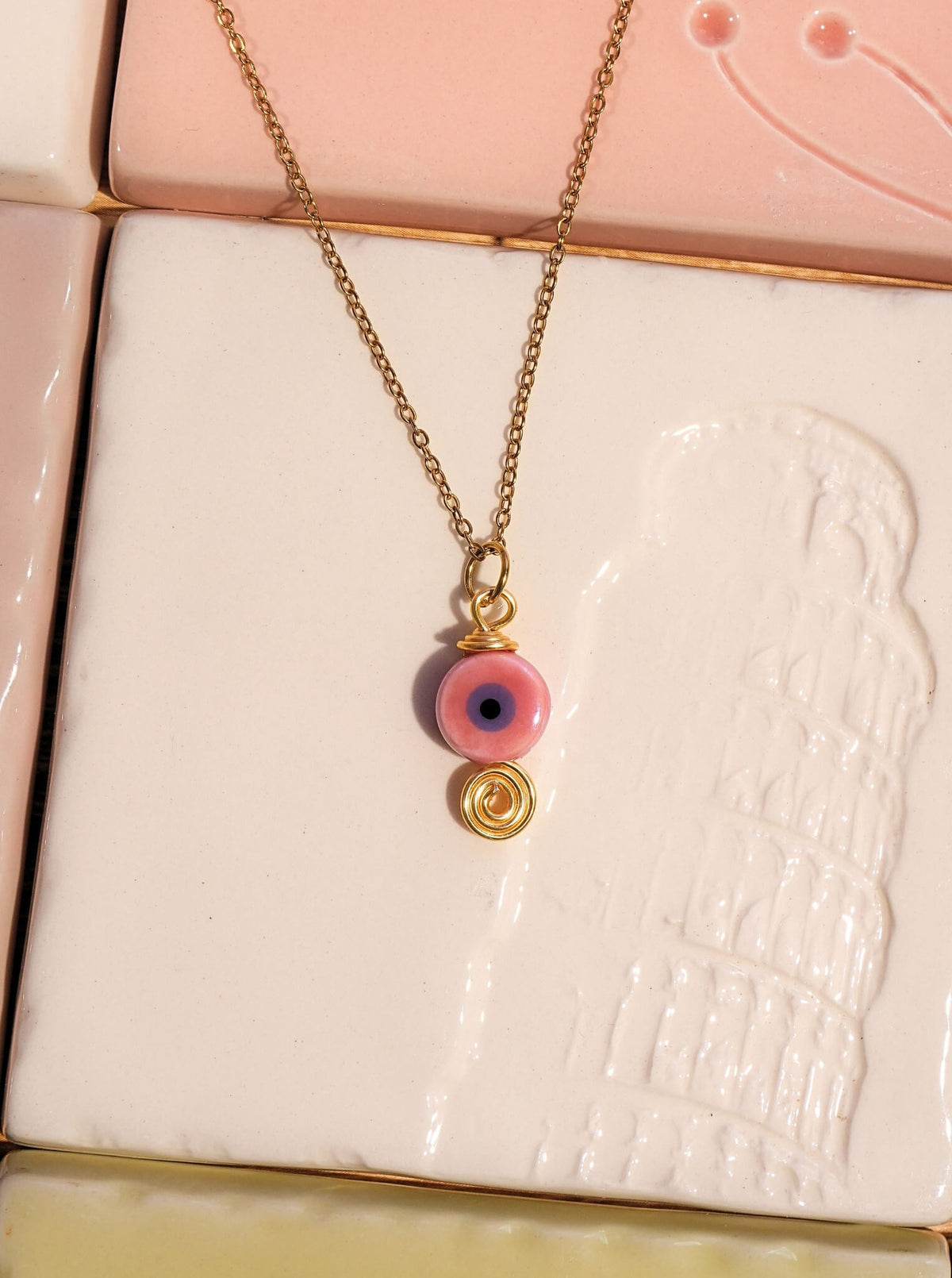 Pink evil eye necklace in elegant gift box showing handmade gold wire wrapped ceramic pendant packaging, Sri Lankan spiritual jewelry gift set featuring pink evil eye talisman as love protection amulet and meaningful gift for her with premium presentation
