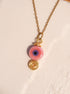 Handmade pink evil eye protection necklace in gold wire wrapped design featuring ceramic evil eye bead and spiral charm, Sri Lankan artisan spiritual jewelry crafted as self-love talisman and protective amulet for women seeking love energy and emotional healing
