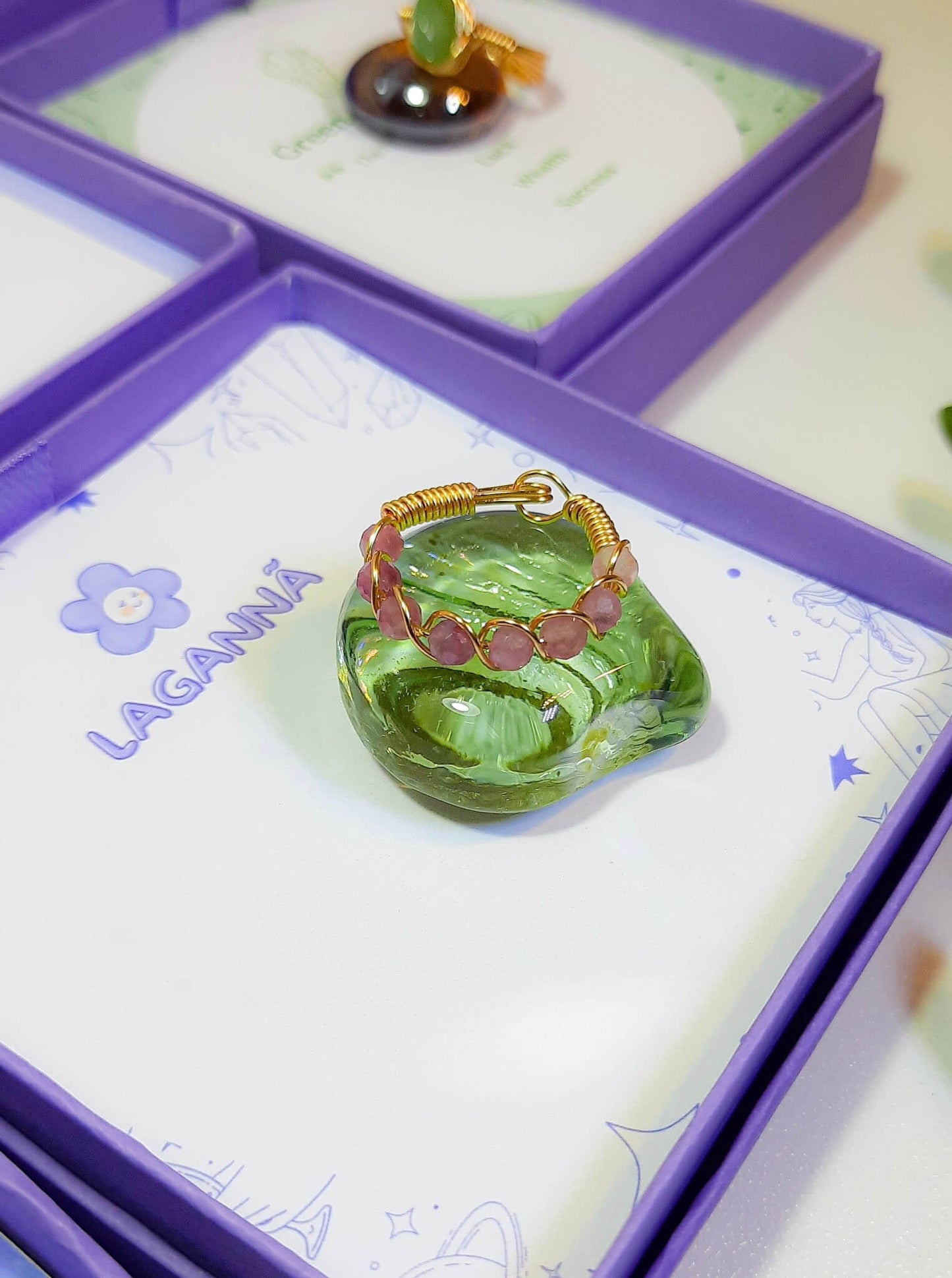 Pink tourmaline braided ring jewelry box aesthetic styling, handmade Sri Lankan gold wire wrapped healing crystal ring for joy and inner happiness