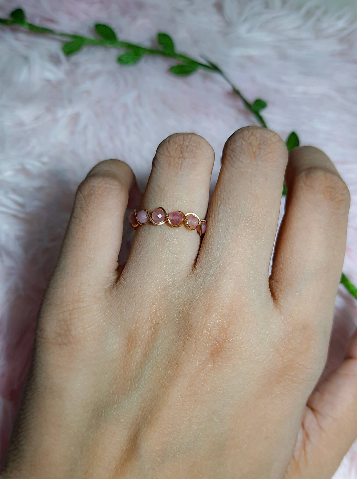 Pink tourmaline braided ring worn on hand, handmade Sri Lankan gold wire wrapped healing crystal ring lifestyle for heart chakra and joyful energy