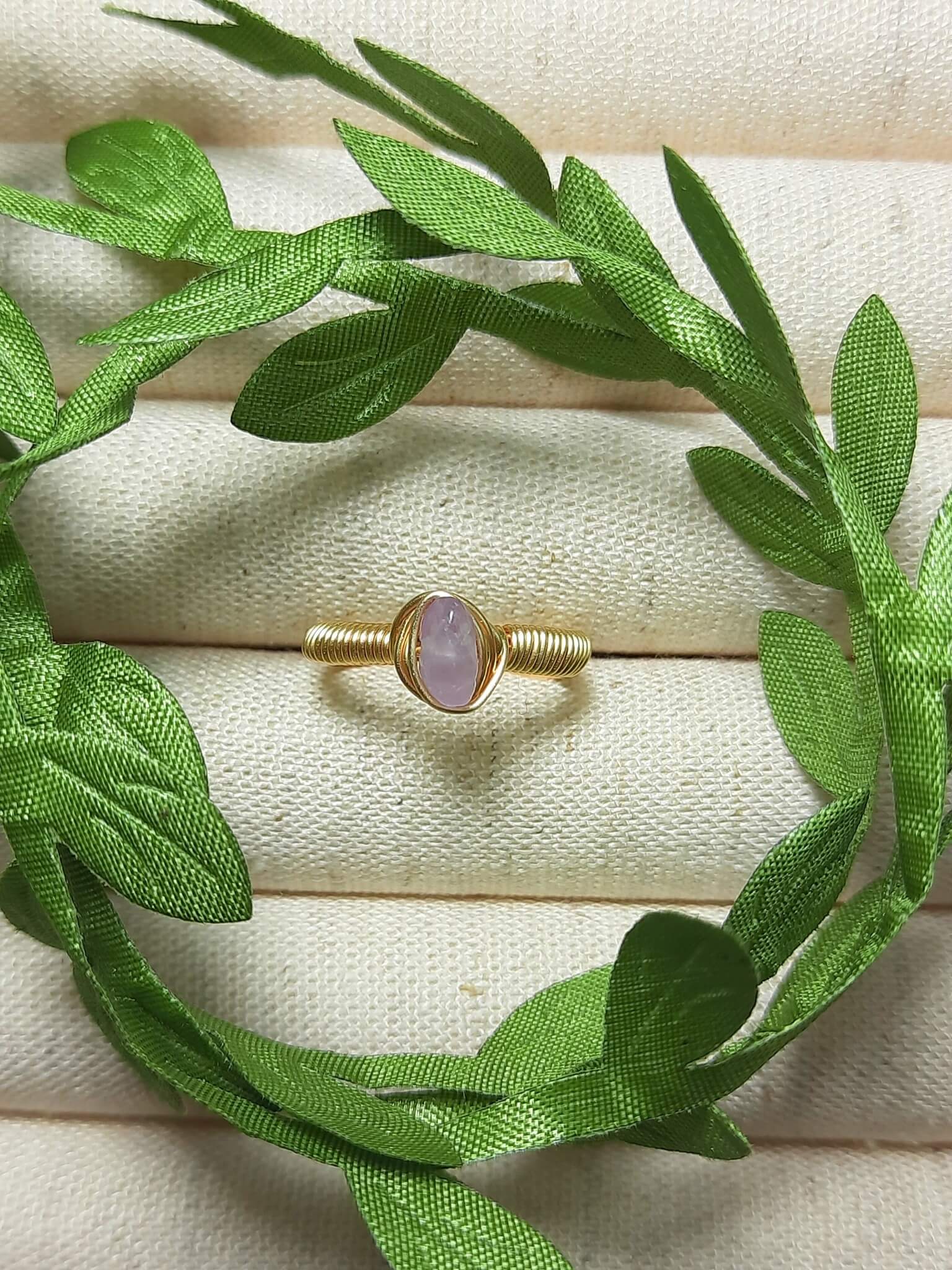 Purple jade irregular stone ring on jewelry display showing handmade gold wire wrapped healing crystal jewelry, Sri Lankan artisan wisdom stone ring featuring natural purple gemstone perfect as boho spiritual ring and crown chakra amulet for meditation and enlightenment energy