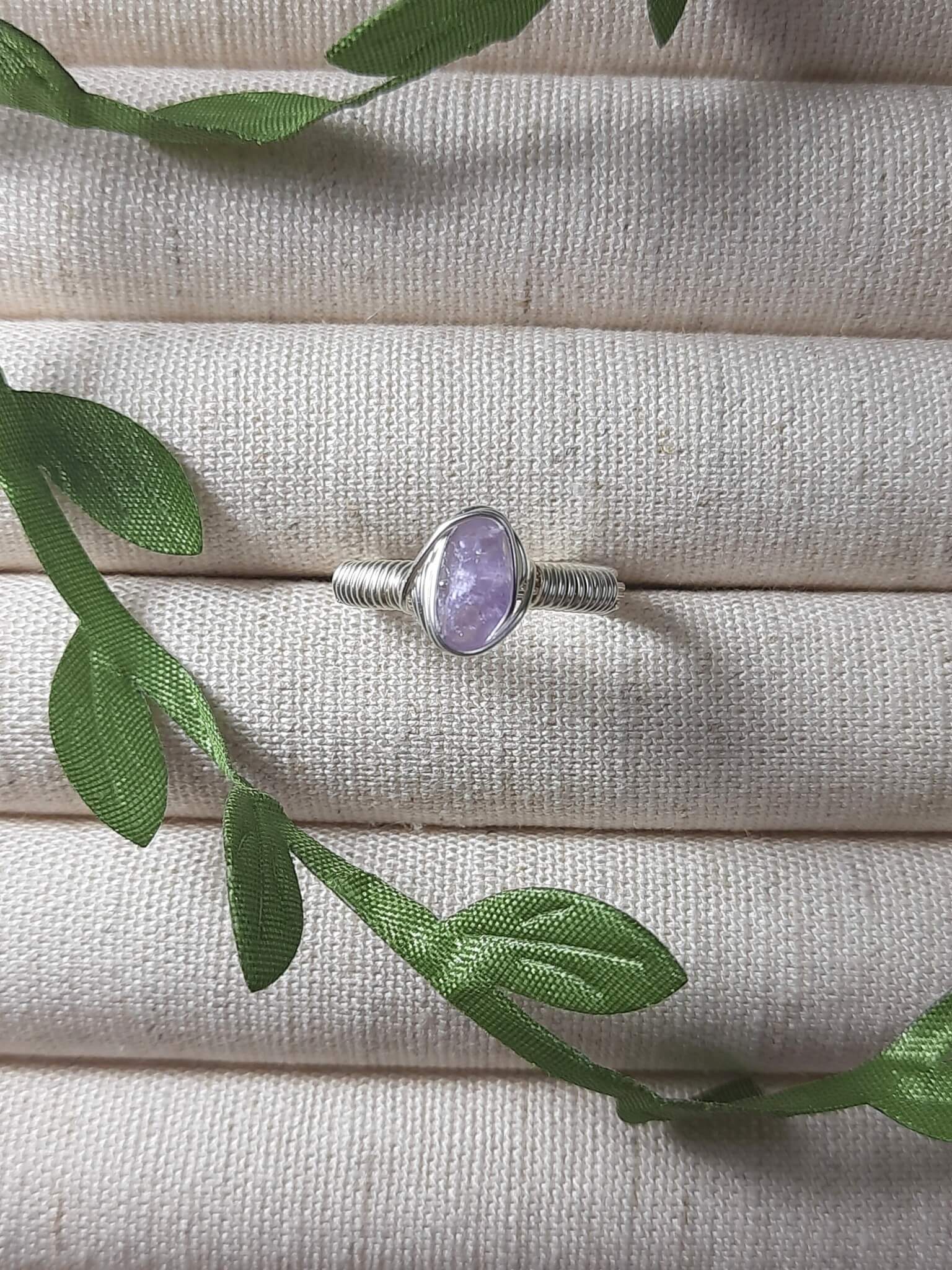 Natural purple jade irregular stone ring on jewelry display showing handmade silver wire wrapped healing crystal jewelry, Sri Lankan artisan wisdom stone ring featuring raw purple gemstone perfect as boho spiritual ring and crown chakra amulet for inner peace and tranquility