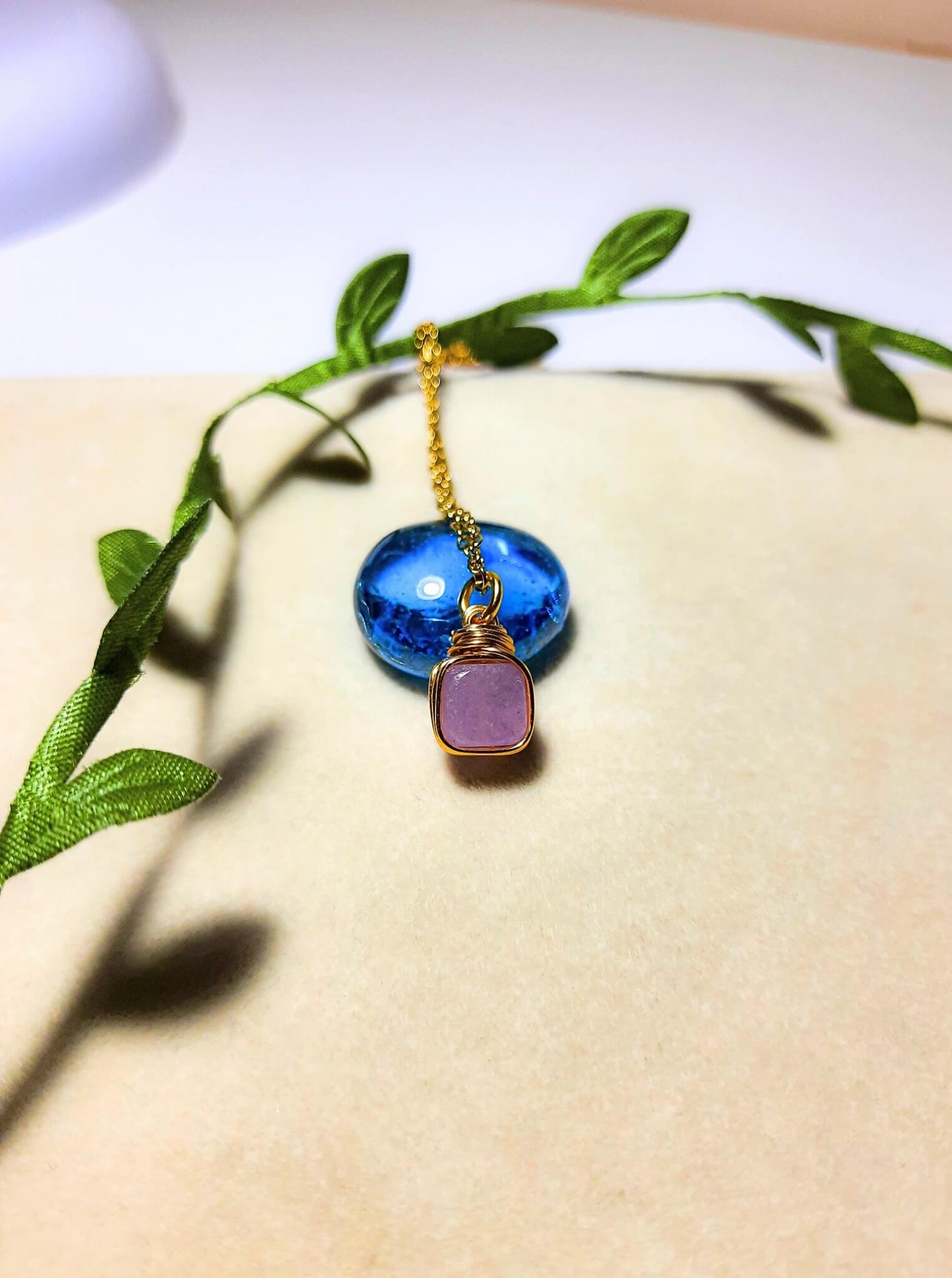 Natural purple jade square stone necklace on aesthetic background showing handmade gold wire wrapped healing crystal jewelry, Sri Lankan artisan crown chakra pendant featuring geometric purple gemstone perfect as boho wisdom necklace and spiritual amulet for inner peace and tranquility