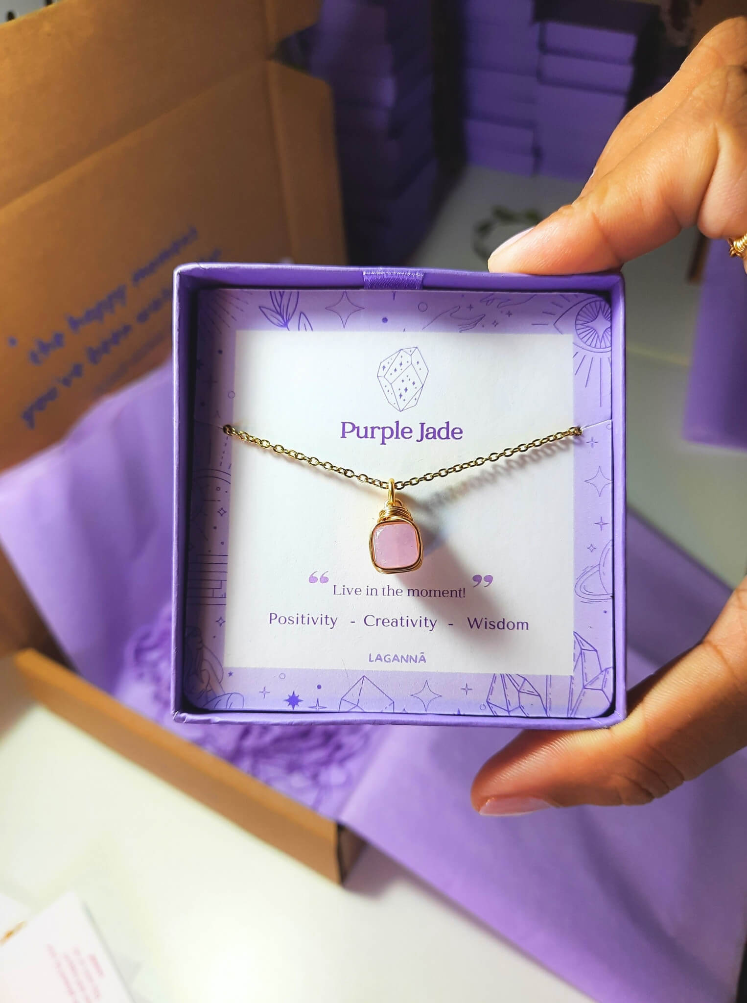 Purple jade square stone necklace jewelry box held in hand showing handmade gold wire wrapped healing crystal gift set, Sri Lankan artisan crown chakra pendant featuring natural square purple gemstone perfect as wisdom jewelry gift for spiritual growth and meditation with elegant presentation