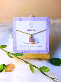  Handmade purple jade square stone necklace in gold wire wrapped design on jewelry card featuring natural healing crystal jewelry crafted by Sri Lankan artisans as crown chakra balancing pendant and wisdom enhancement amulet for women seeking spiritual growth and inner peace with geometric purple gemstone
