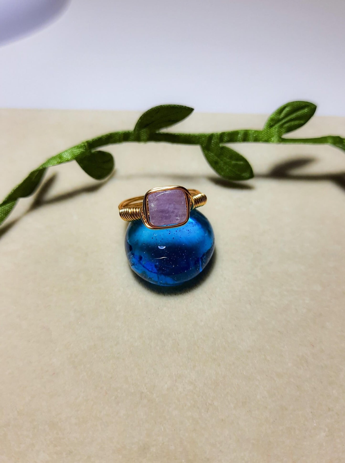 Natural purple jade square stone ring on aesthetic background showing handmade gold wire wrapped healing crystal jewelry, Sri Lankan artisan crown chakra ring featuring geometric purple gemstone perfect as boho wisdom ring and spiritual amulet for meditation and tranquility