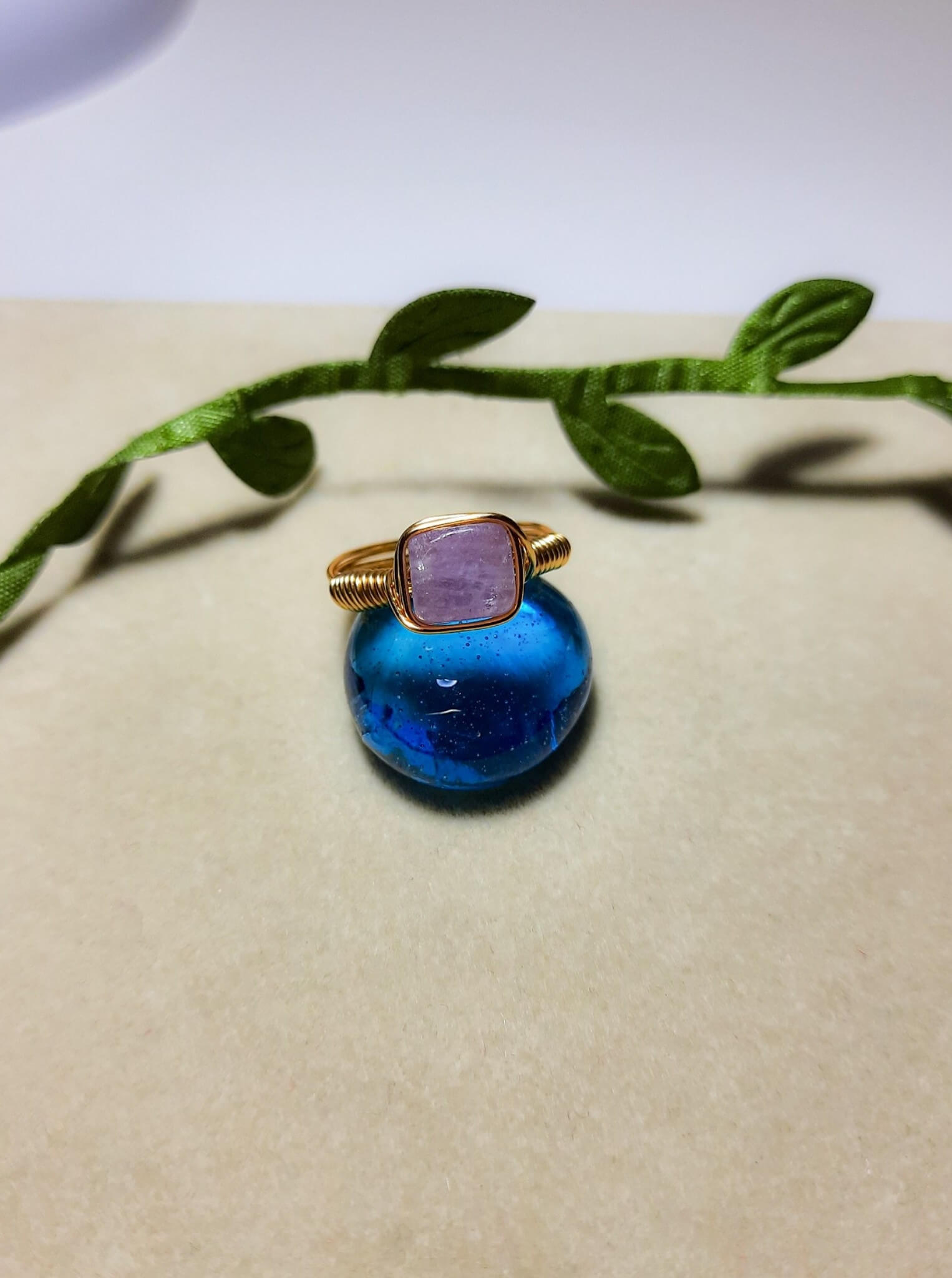 Natural purple jade square stone ring on aesthetic background showing handmade gold wire wrapped healing crystal jewelry, Sri Lankan artisan crown chakra ring featuring geometric purple gemstone perfect as boho wisdom ring and spiritual amulet for meditation and tranquility