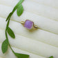 Handmade purple jade square stone ring in gold wire wrapped design on aesthetic jewelry display featuring natural healing crystal jewelry crafted by Sri Lankan artisans as crown chakra balancing ring and wisdom enhancement amulet for women seeking spiritual growth and inner peace with geometric purple gemstone