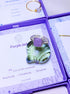 Purple jade square stone ring in silver wire wrapped design in jewelry box showing handmade healing crystal gift set, Sri Lankan artisan crown chakra ring featuring natural square purple gemstone perfect as wisdom jewelry gift for spiritual awakening and inner peace with elegant presentation