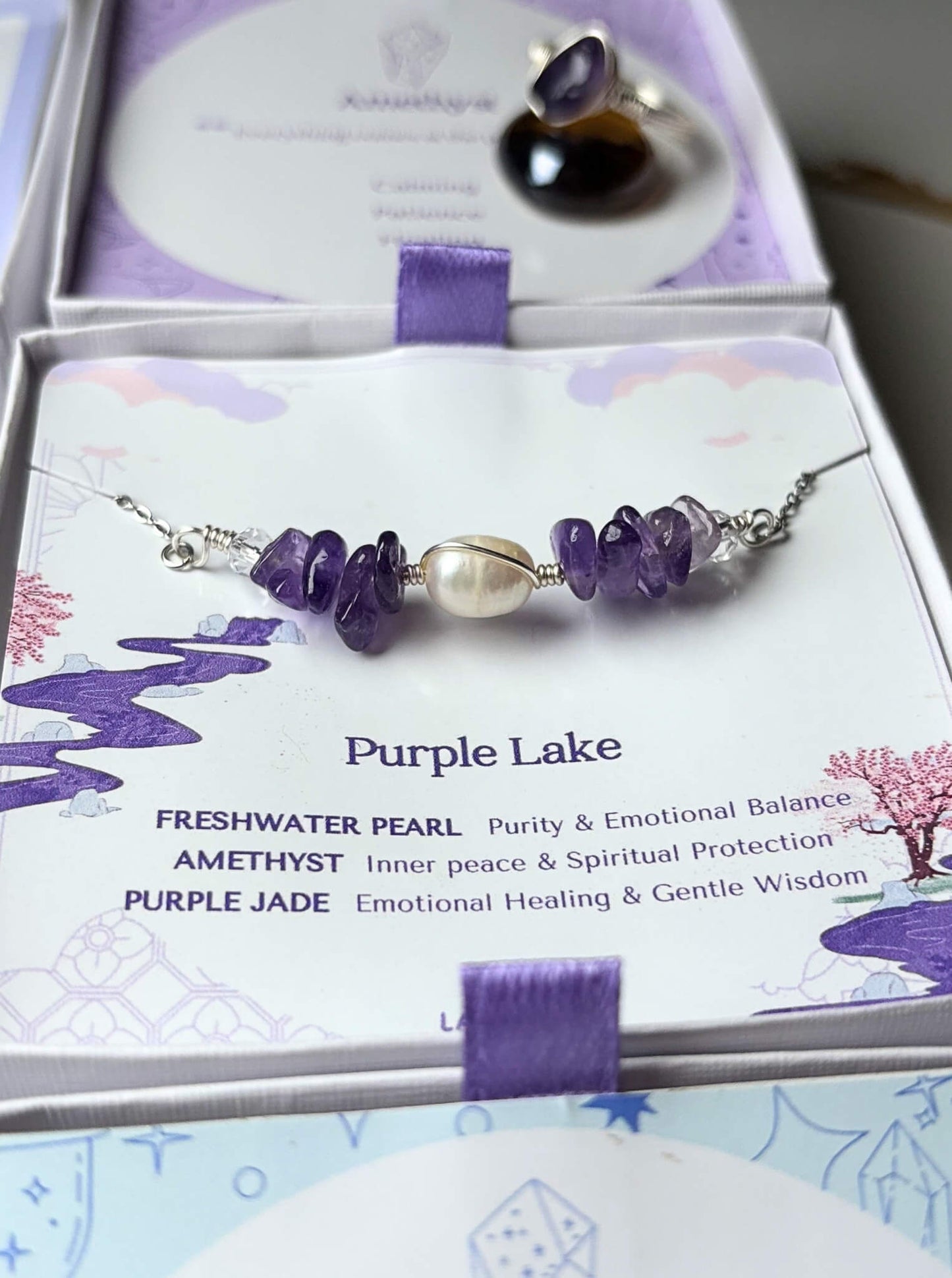 Purple Lake Bracelet silver wire wrapped amethyst freshwater pearl purple jade close-up in Laganna gift box showing crystal meaning card – purity inner peace emotional healing, handmade crystal bracelet Sri Lanka

