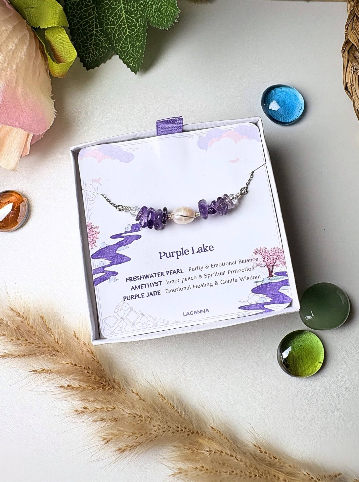 Purple Lake Bracelet silver wire wrapped amethyst freshwater pearl purple jade in Laganna jewelry box overhead flat lay with pampas grass and glass stones, handmade healing crystal bracelet Sri Lanka – spiritual protection gentle wisdom
