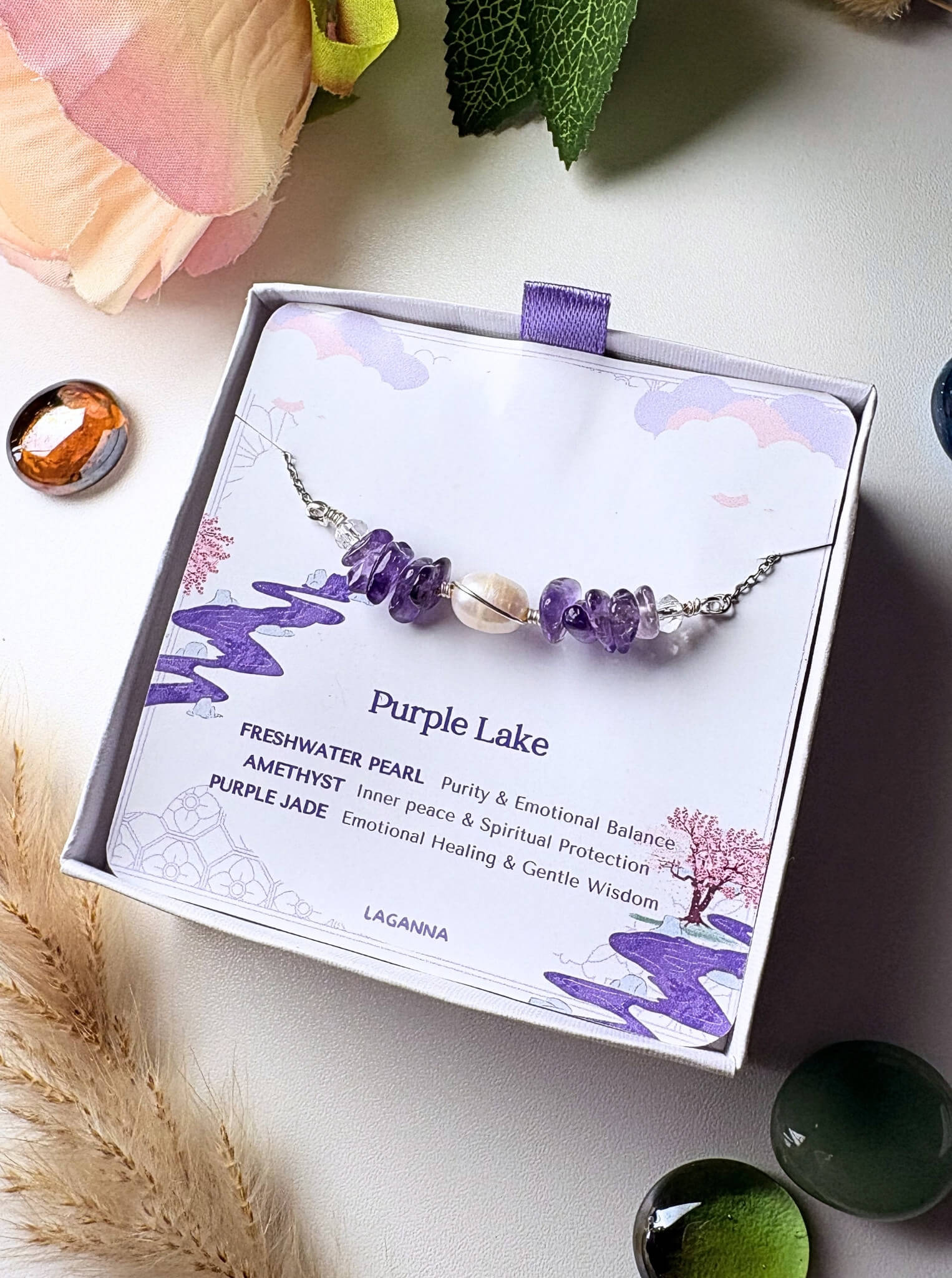 Purple Lake Bracelet amethyst freshwater pearl purple jade silver wire wrapped in Laganna jewelry box overhead flat lay with pampas grass styling, handmade healing crystal bracelet Sri Lanka – purity inner peace emotional healing

