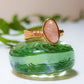  Handmade rose quartz irregular stone ring in gold wire wrapped design featuring natural healing crystal jewelry crafted by Sri Lankan artisans as love stone ring and heart chakra balancing amulet for women seeking self-love and emotional healing with raw gemstone energy