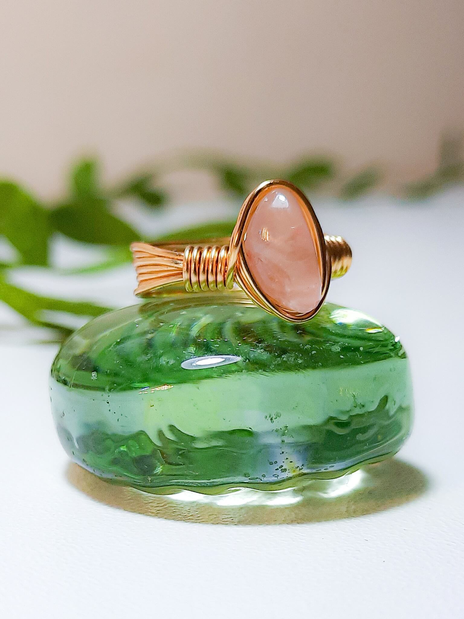  Handmade rose quartz irregular stone ring in gold wire wrapped design featuring natural healing crystal jewelry crafted by Sri Lankan artisans as love stone ring and heart chakra balancing amulet for women seeking self-love and emotional healing with raw gemstone energy