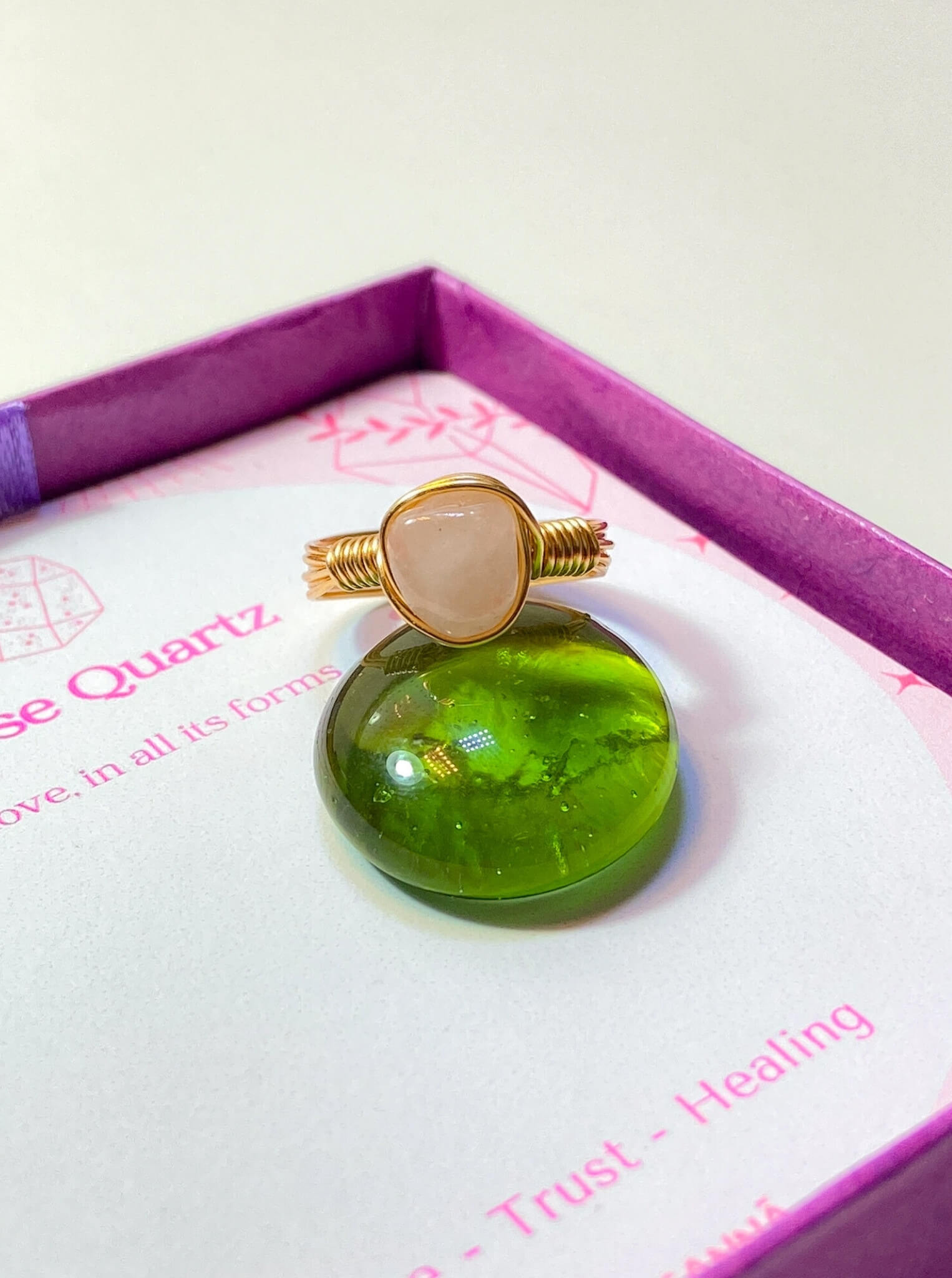 Handmade rose quartz irregular stone ring in elegant pink Laganna jewelry box showing gold wire wrapped healing crystal gift set, Sri Lankan artisan love stone ring featuring natural gemstone perfect as heart chakra jewelry gift for emotional healing and self-love
