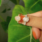 Rose quartz irregular stone rings holding on hand showing both gold and silver wire wrapped designs, handmade Sri Lankan healing crystal jewelry featuring natural pink gemstones perfect as boho love stone rings and heart chakra amulets for emotional balance and self-love lifestyle 