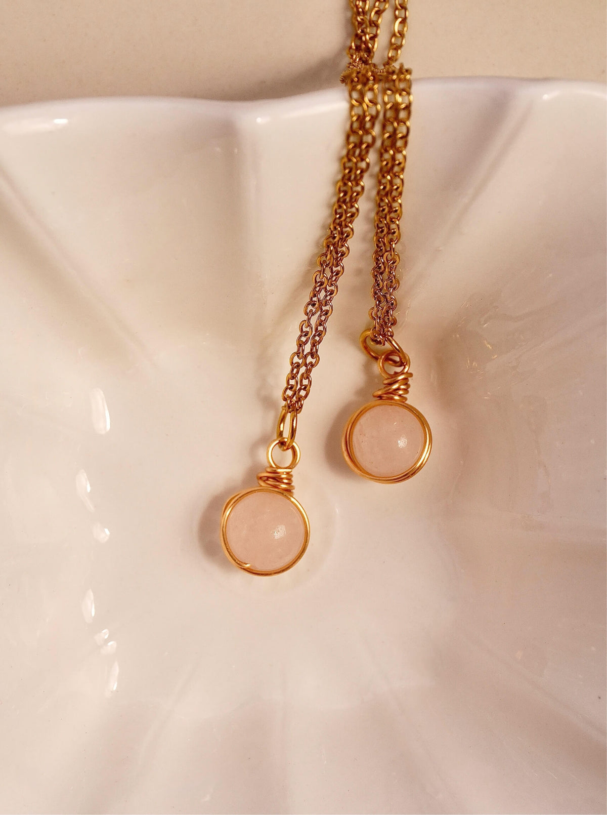 Rose Quartz Statement Round Stone Necklace gold wire wrapped round pendant double styling on white ceramic surface flat lay, handmade healing crystal jewelry Sri Lanka Laganna
