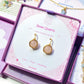 Rose Quartz Statement Round Stud Earrings packaging with crystal meaning card - handcrafted wire-wrapped healing jewelry gift from Sri Lanka featuring natural rose quartz stone for love, tenderness, and compassion
