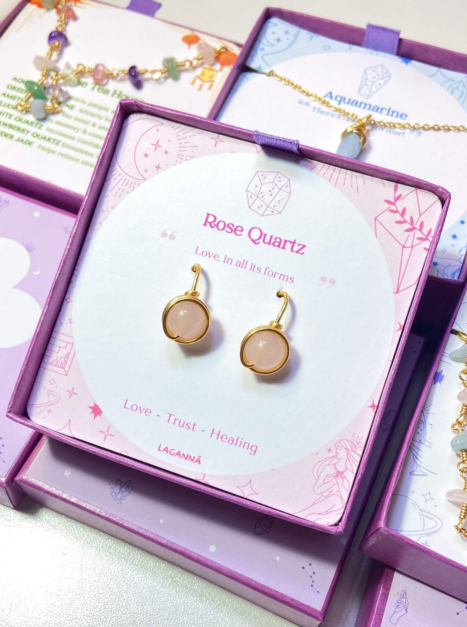 Rose Quartz Statement Round Stud Earrings packaging with crystal meaning card - handcrafted wire-wrapped healing jewelry gift from Sri Lanka featuring natural rose quartz stone for love, tenderness, and compassion
