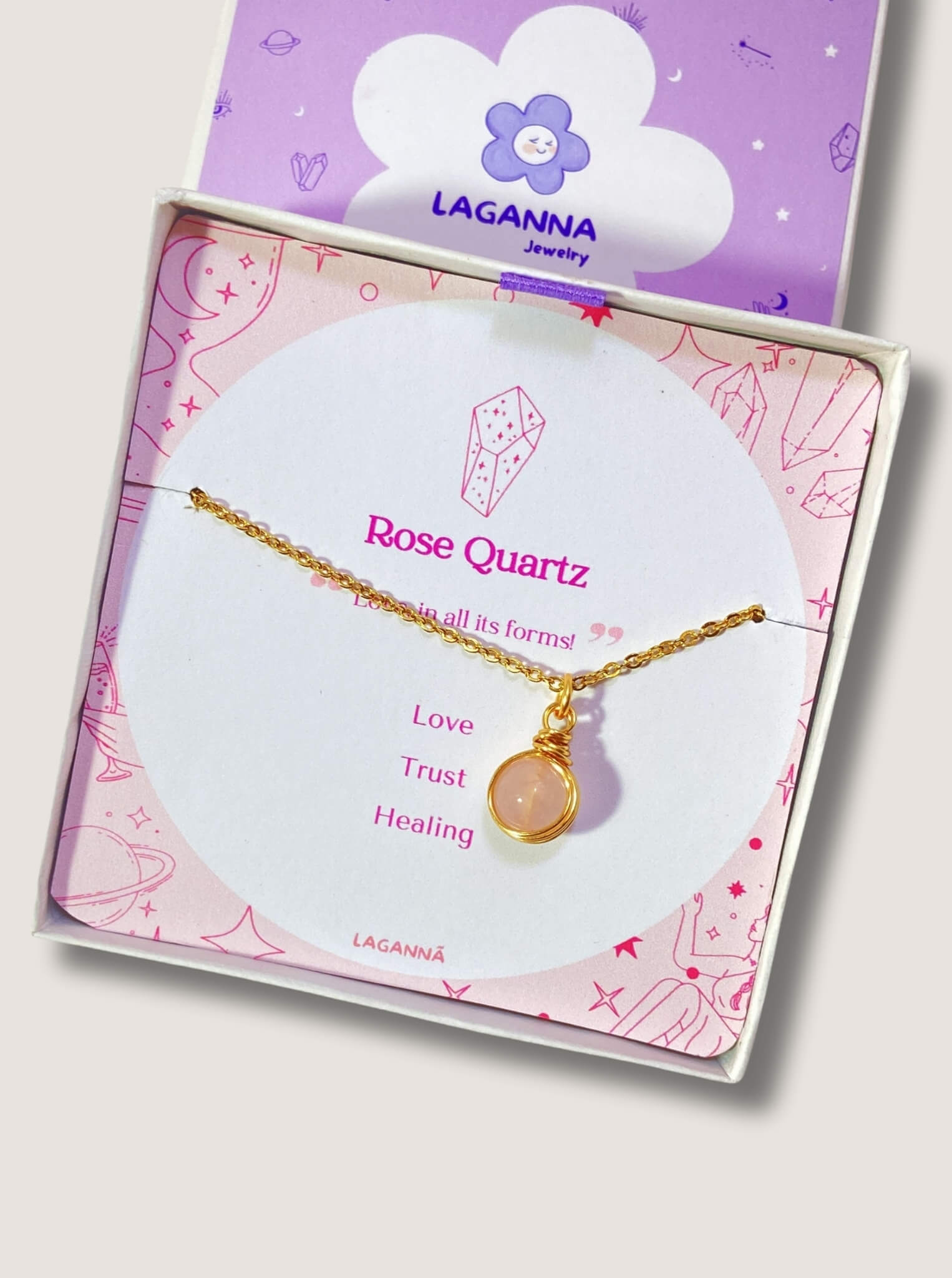 Beautiful rose quartz round pendant necklace on clean white background with jewelry box, featuring delicate gold wire wrapping - artisan-crafted healing crystal jewelry handmade in Sri Lanka for self-love and acceptance