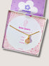 Beautiful rose quartz round pendant necklace on clean white background with jewelry box, featuring delicate gold wire wrapping - artisan-crafted healing crystal jewelry handmade in Sri Lanka for self-love and acceptance
