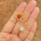 Beautiful Sun & Moon Dangle Earrings featuring Carnelian and Opalite healing crystals, handmade gold wire wrapped celestial jewelry from Sri Lanka by Laganna, shown on hand stylish bohemian accessories
