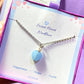 Sweet heart blue chalcedony necklace jewelry box held on hand showing silver wire wrapped design, handmade Sri Lankan heart-shaped pendant gift for calm and emotional healing