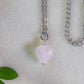 Sweet heart rose quartz necklace on soft background with leaves showing handmade silver wire wrapped healing crystal jewelry, Sri Lankan artisan heart chakra pendant featuring natural heart-shaped pink gemstone perfect as boho love necklace and self-love amulet for emotional balance and inner peace