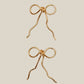 Wire-wrapped bow earrings detail shot showing delicate bow design and wire-wrapping craftsmanship, handmade artisan jewelry by Laganna Sri Lanka, available in gold plated or silver plated finish with or without Japanese Miyuki Delica glass beads, feminine lightweight earrings for women, premium handcrafted stud earrings
